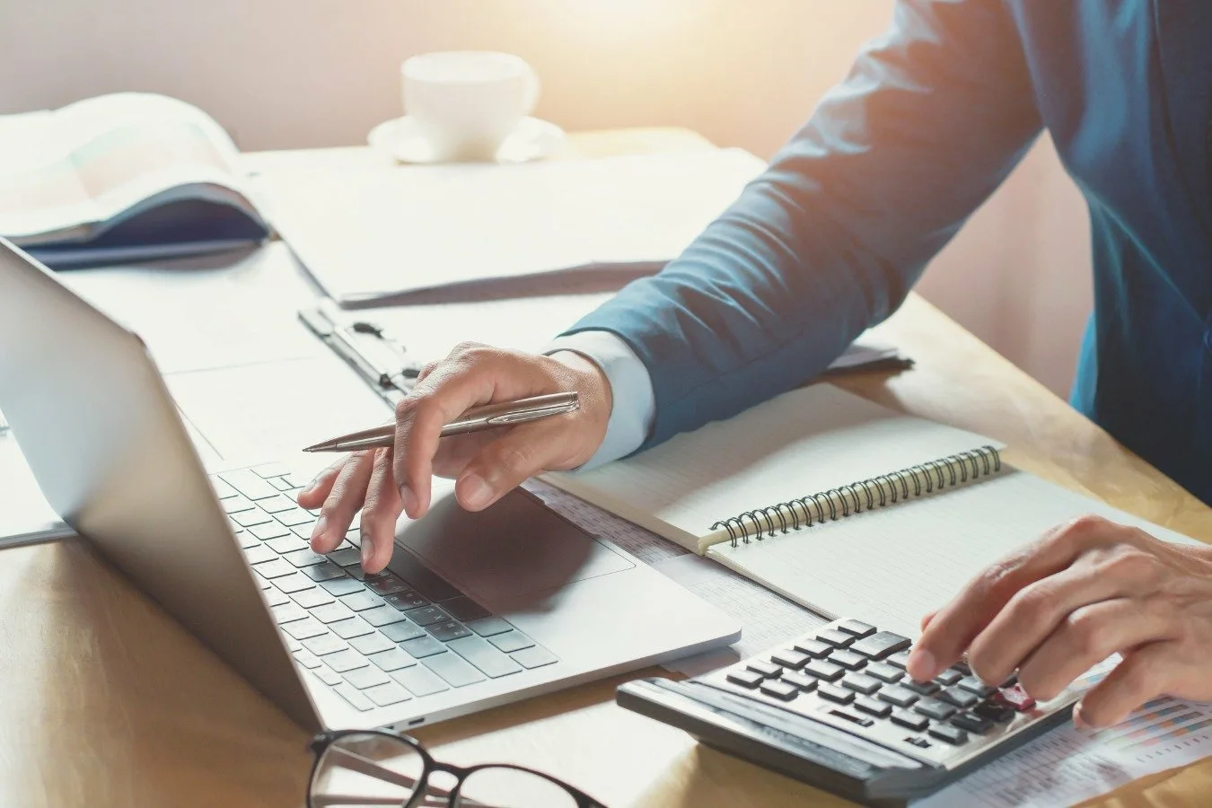 Business professional analyzing financial data on a laptop.