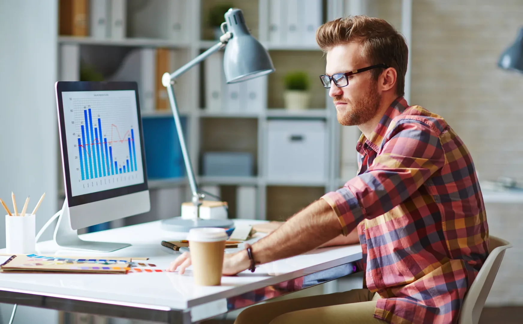 Man working on computer analyzing data at nocode-profit.com