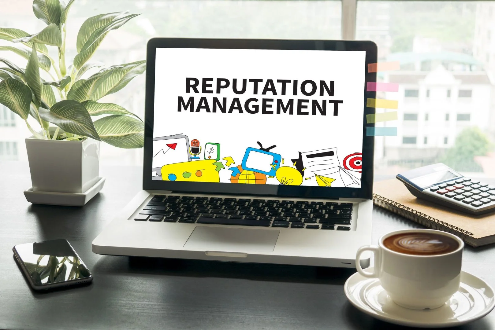 Laptop displaying reputation management tools on desk.